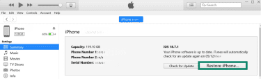 iTunes app on Windows laptop with Restore iPhone button highlighted.